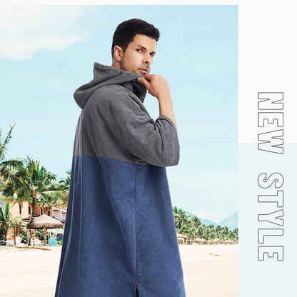 Man wearing a stylish hooded quick-dry towel poncho at the beach, showcasing cozy and versatile design for surfers.