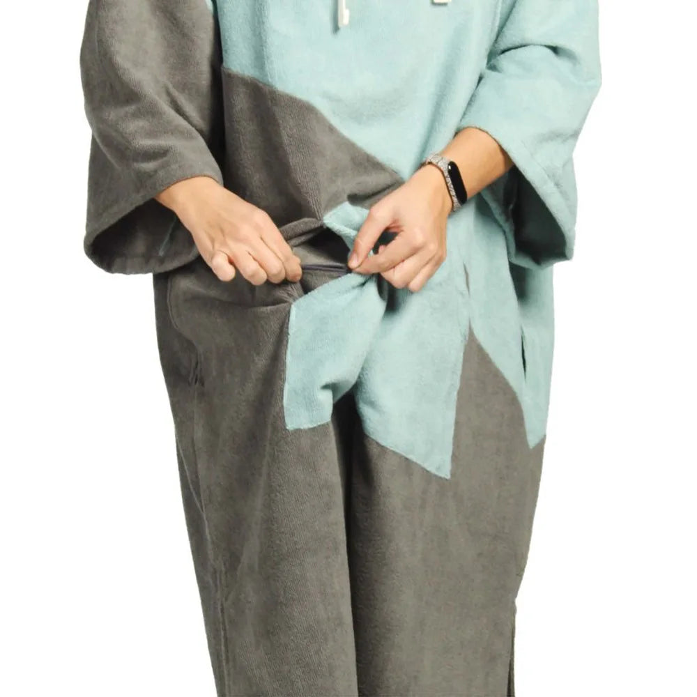 User adjusting the waistband of a thickened swimming diving hooded bathrobe in blue and gray colors.