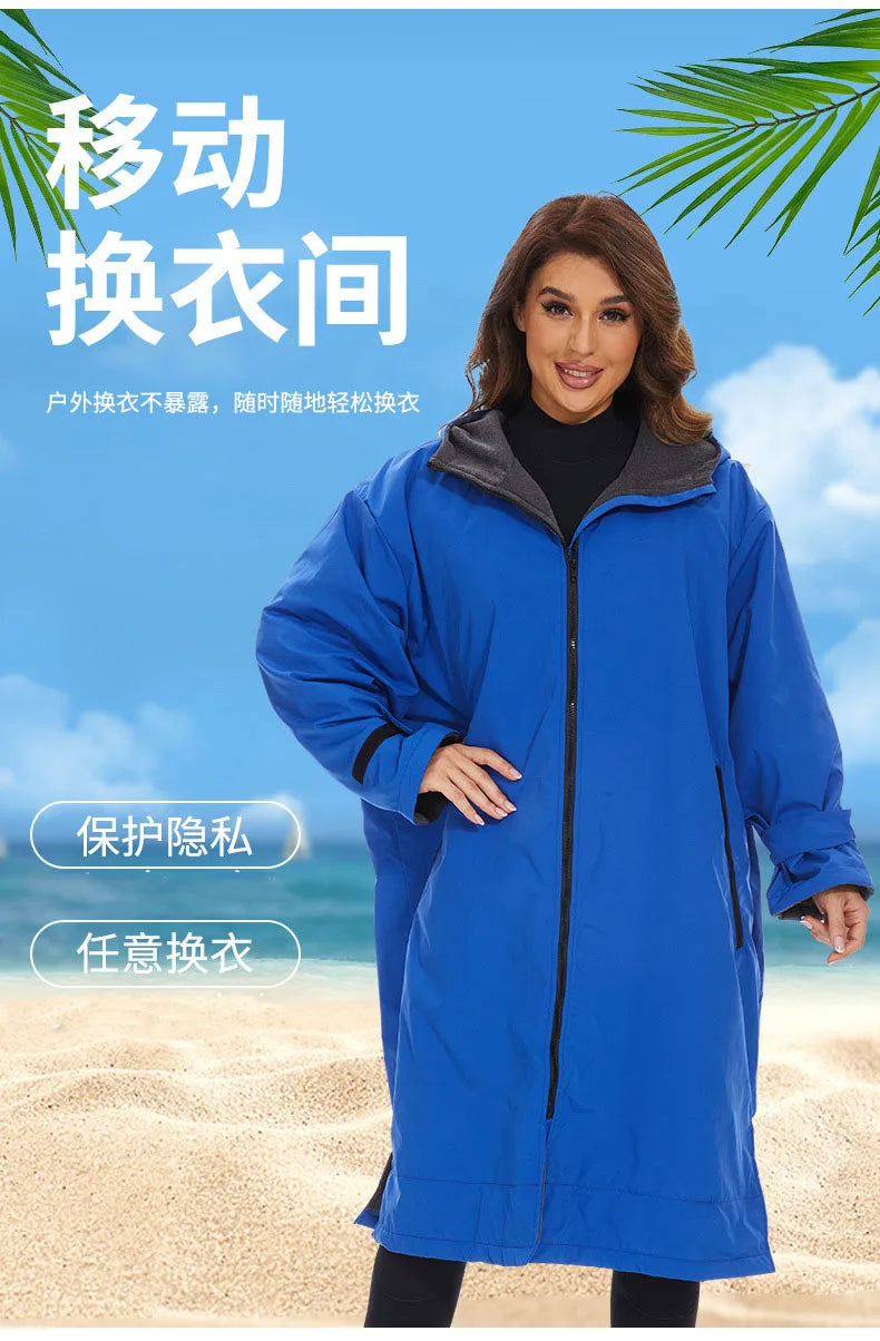 Woman in a blue hooded changing robe on a beach, showcasing a stylish and functional design for water activities.