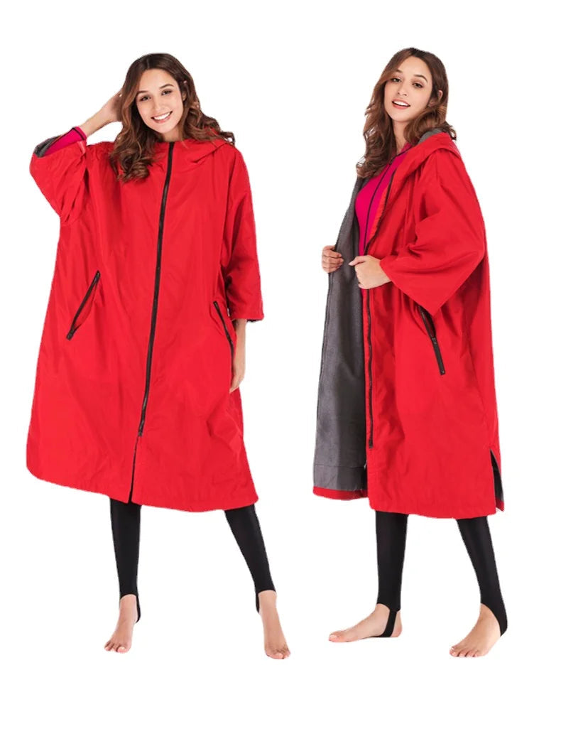 Waterproof surf changing robe in bright red, showcasing fleece lining and a hood for warmth and comfort during water activities.